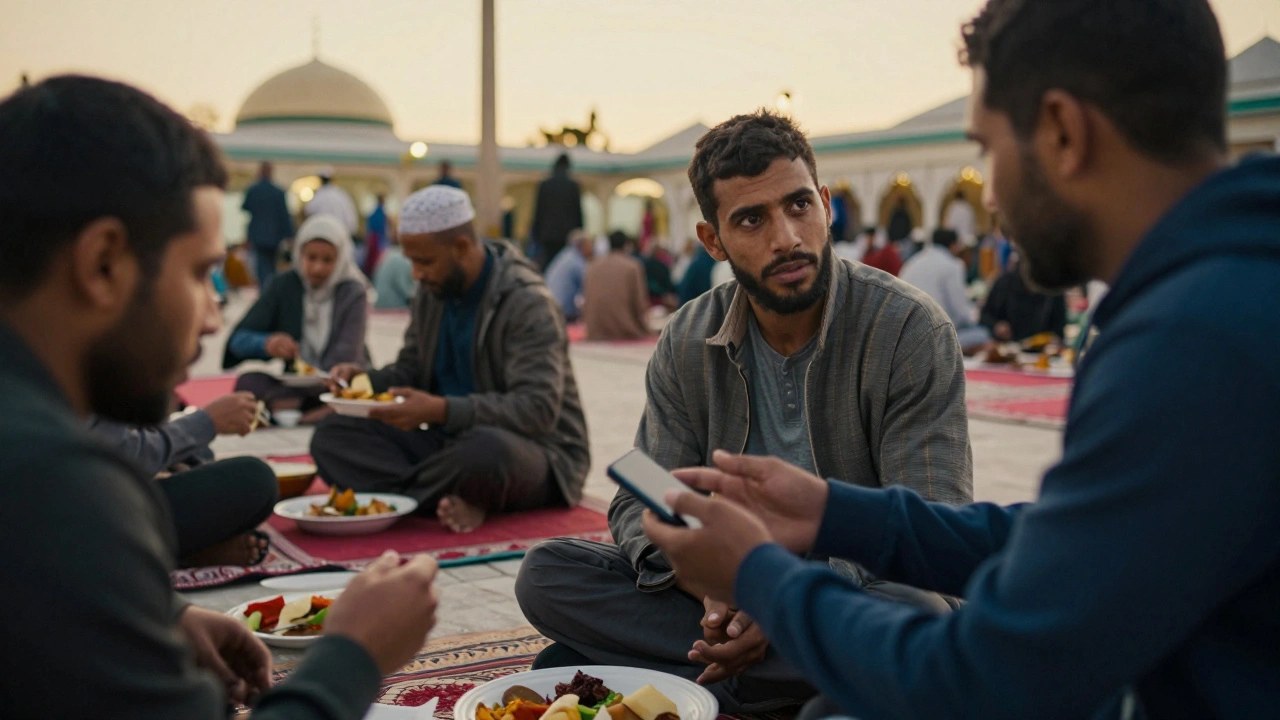 A volunteer hands a charged phone to a migrant worker in a mosque courtyard at dusk.