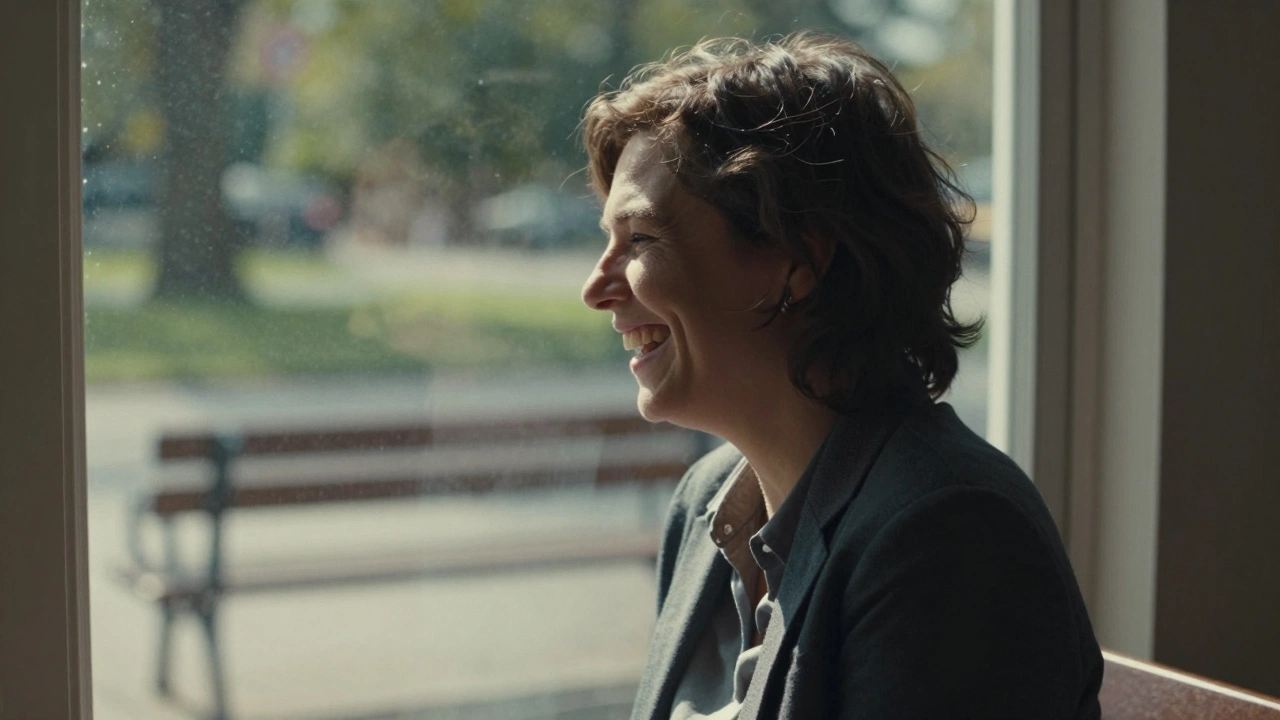 Candid moment laughing while looking out a window, soft daylight and quiet background.